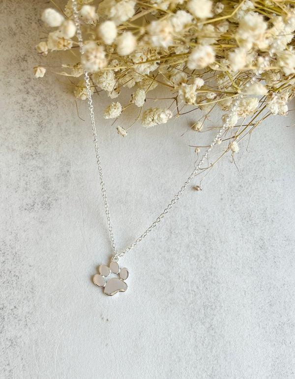 Elegant silver pendant with paw print on a chain